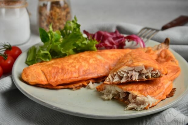 Mackerel fillet in tomato batter in a frying pan