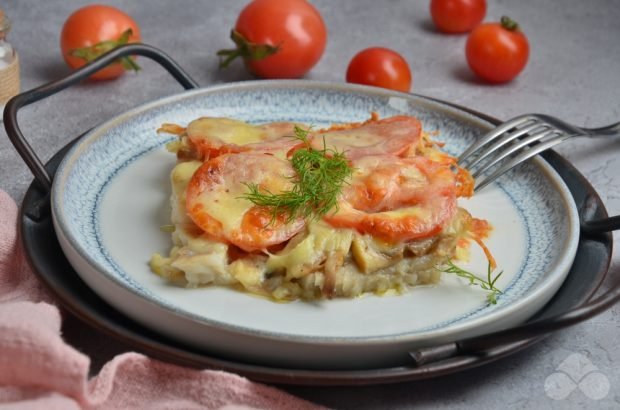 Pollock with mushrooms, tomatoes and cheese in the oven