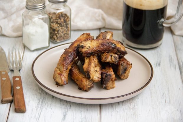 Pork ribs in beer in a frying pan