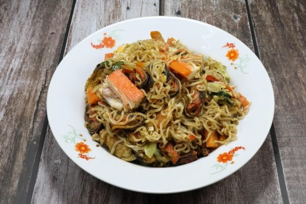 Noodles with crab sticks and mussels are a simple and delicious recipe for cooking step by step