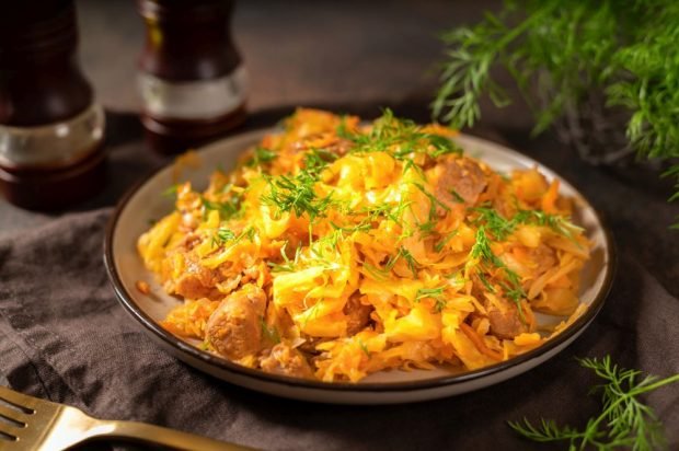 Stewed cabbage with turkey in a frying pan