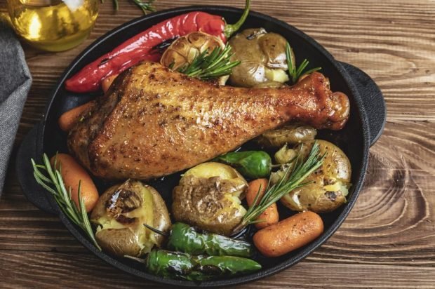 Baked turkey drumstick with vegetables