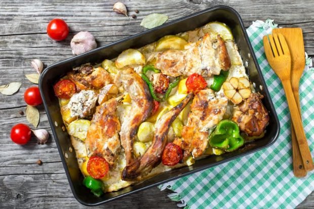 Rabbit with vegetables and sour cream in the oven