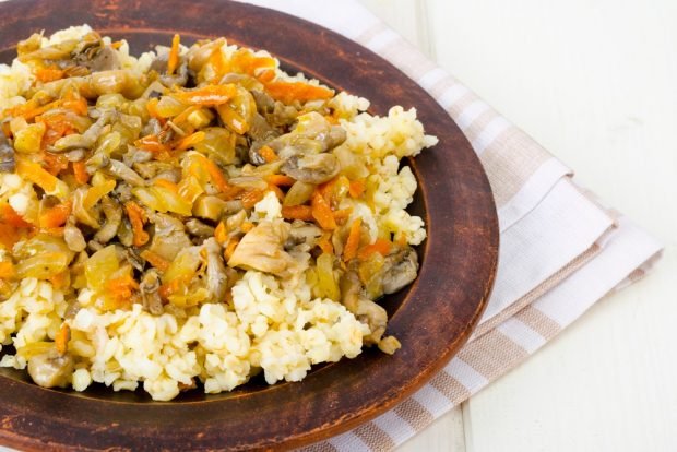 Wheat porridge with mushrooms and vegetables in a slow cooker 