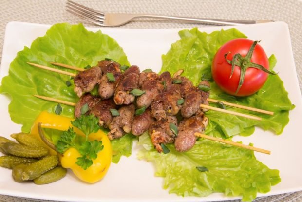 Shish kebab of chicken hearts in the oven on skewers