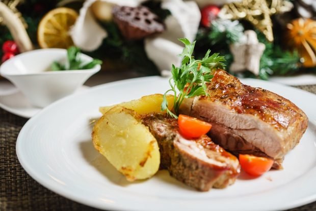 Pork ribs with potatoes in the oven under foil