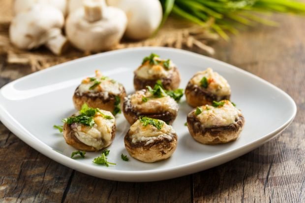 Champignons with cheese on the grill