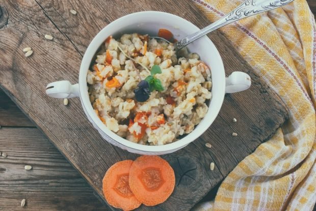 Pearl porridge with carrots and dried fruits in a slow cooker