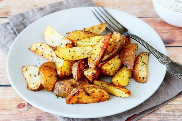 Rustic potatoes with Provencal herbs in a frying pan