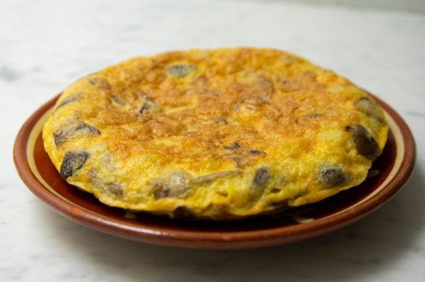 An omelet with potatoes, mushrooms and onions in the oven 