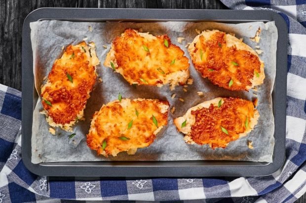 Chicken chops with pineapples, garlic and cheese in the oven