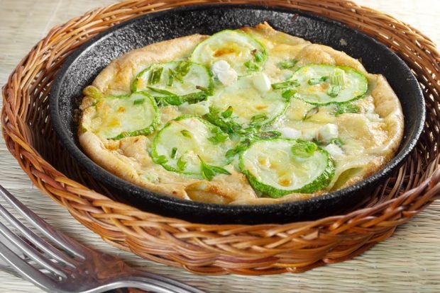 Zucchini casserole with egg in a frying pan