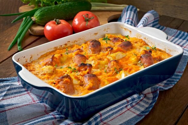 Potato casserole with sausages and pumpkin sauce