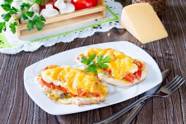 Turkey chops with tomatoes, mushrooms and cheese in the oven