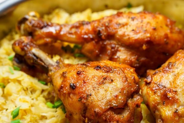 Chicken legs in a frying pan with cabbage