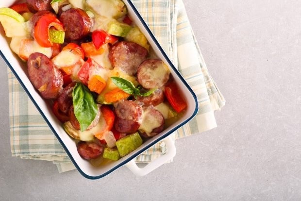 Zucchini casserole with sausages and vegetables