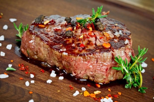 Spicy veal steak in a frying pan