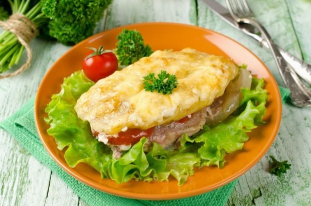 Beef chops with tomatoes, potatoes and onions in the oven