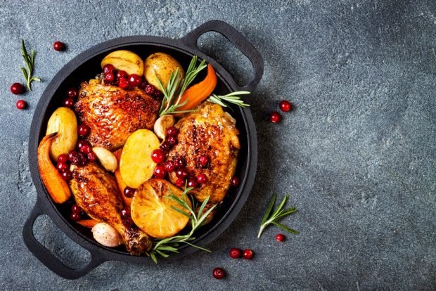 Chicken legs in a frying pan with new potatoes