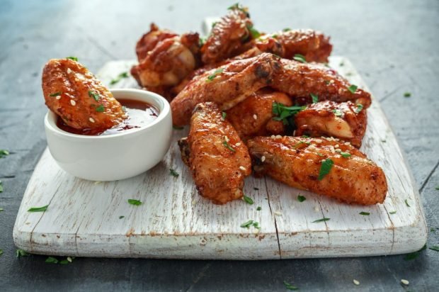 Chicken wings with tomato sauce and spices in the oven