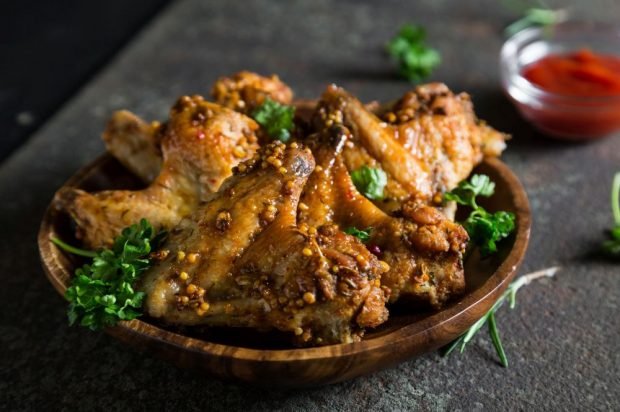 Chicken wings with Dijon mustard, honey and spices in the oven