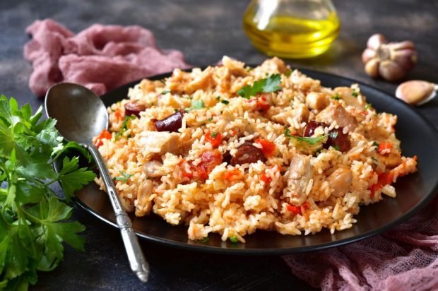 Pilaf with sausage, chicken and tomatoes 