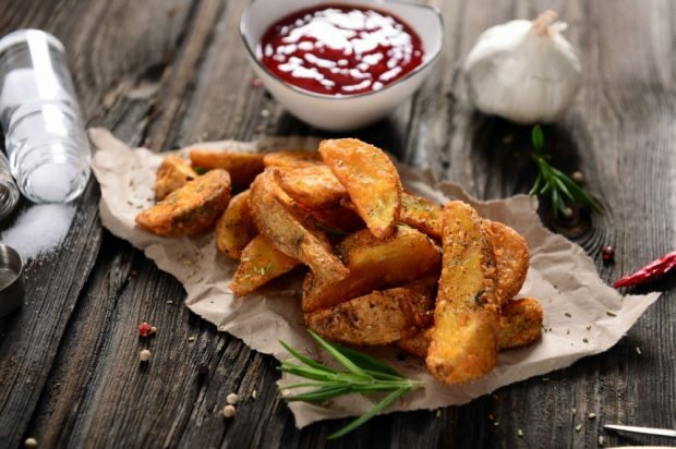 Rustic potatoes with spices in a frying pan