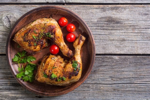 Chicken legs in mayonnaise in a frying pan