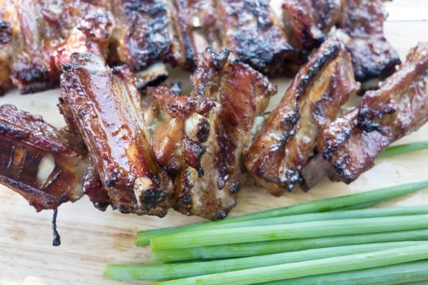 Barbecue pork ribs in marinade on the grill