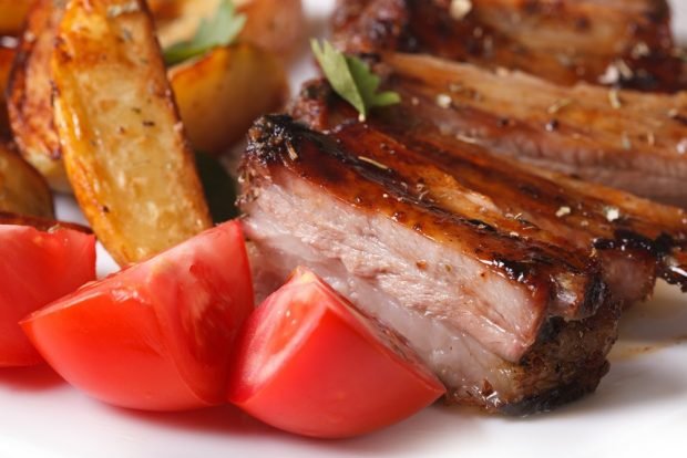 Pork ribs with potatoes in a frying pan