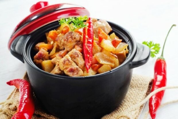 Spicy stew of pork and vegetables in pots