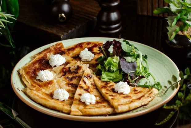 Khachapuri with cottage cheese and cheese in a frying pan 