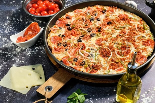 Pizza with minced meat in a frying pan 