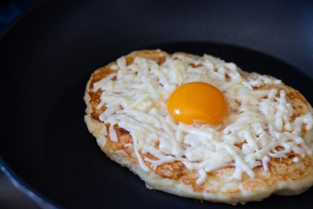 Khachapuri with cheese and egg in a frying pan 