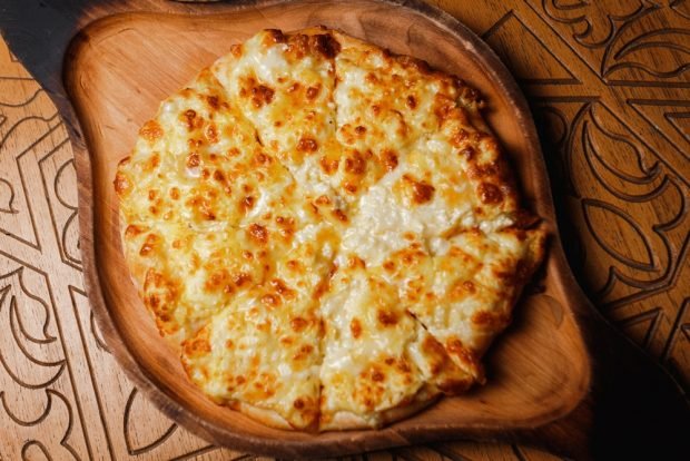 Khachapuri with cheese in a frying pan 