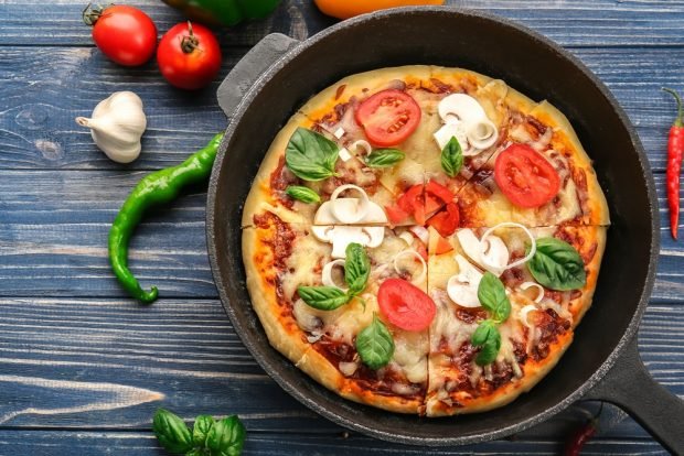 Pizza with mushrooms and basil