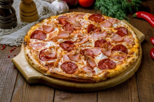 Thin pizza with bacon and salami