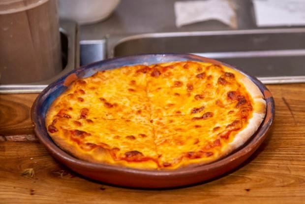 Khachapuri with minced meat and tomatoes in a frying pan 