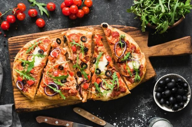 Unusual pizza with mozzarella, olives and onions