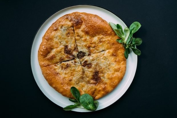 Khachapuri with minced meat in a frying pan 