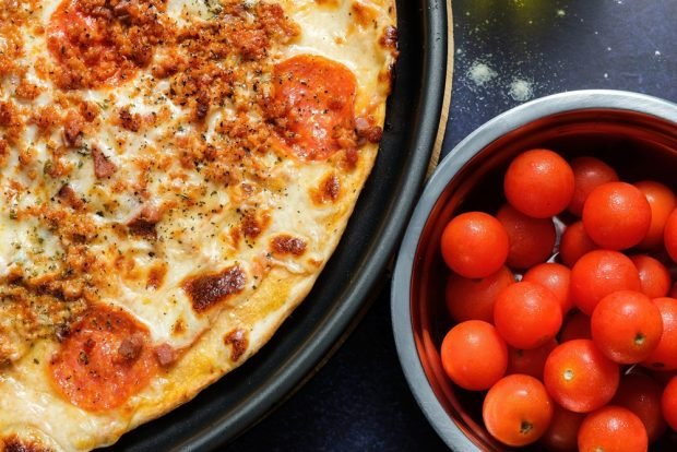 Meat pizza in a frying pan