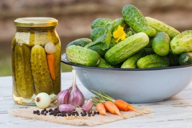 Crispy pickled cucumbers with onions and carrots for winter