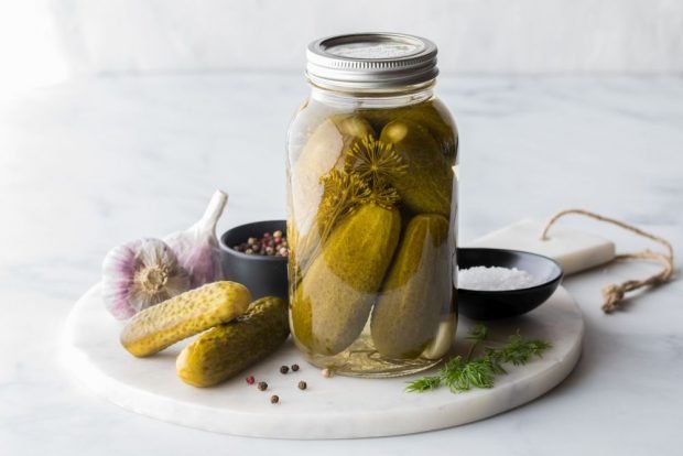 Pickled cucumbers with vinegar for winter in jars