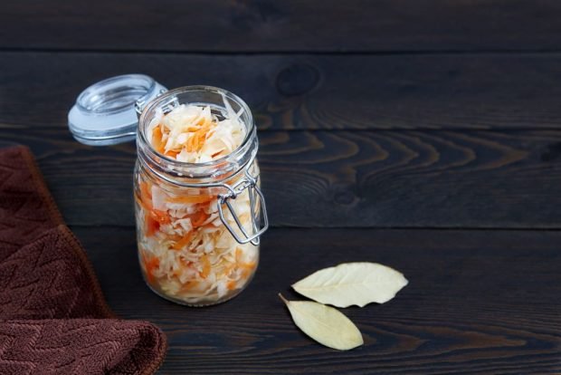 Sauerkraut in a jar with carrots for the winter