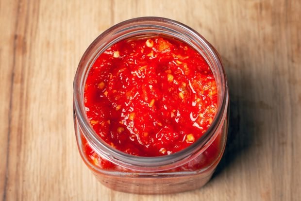 Spicy adjika from zucchini with tomato paste 