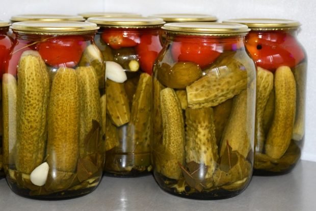 Pickled cucumbers with tomatoes for winter in jars