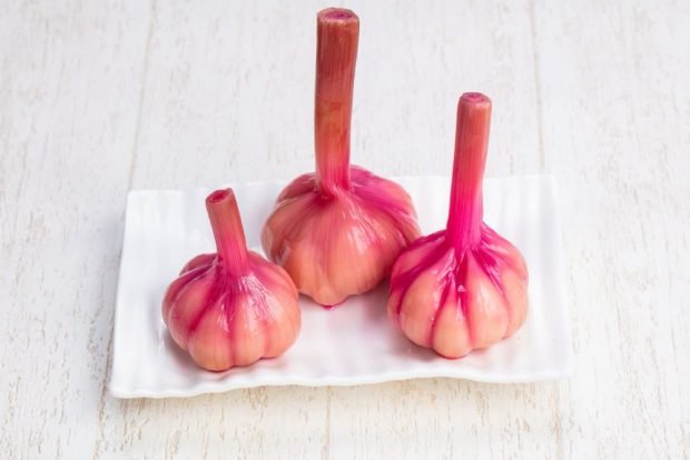 Pickled garlic heads with beetroot for winter