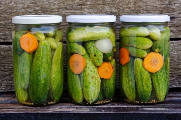 Pickled cucumbers with carrots and onions for winter