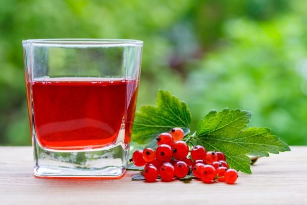 Red currant juice in a juicer for the winter