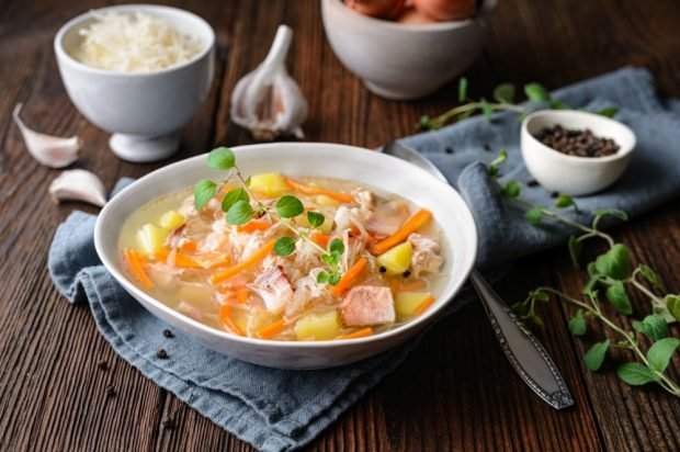 Polish cabbage soup with pork, bacon and vegetables